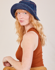 Margaret is wearing the Wide Brim Denim Bucket Hat in dark wash