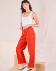 Side view of Mid-Rise Pleated Trousers in Chili Red and Cropped Tank in vintage tee off-white worn by Alex