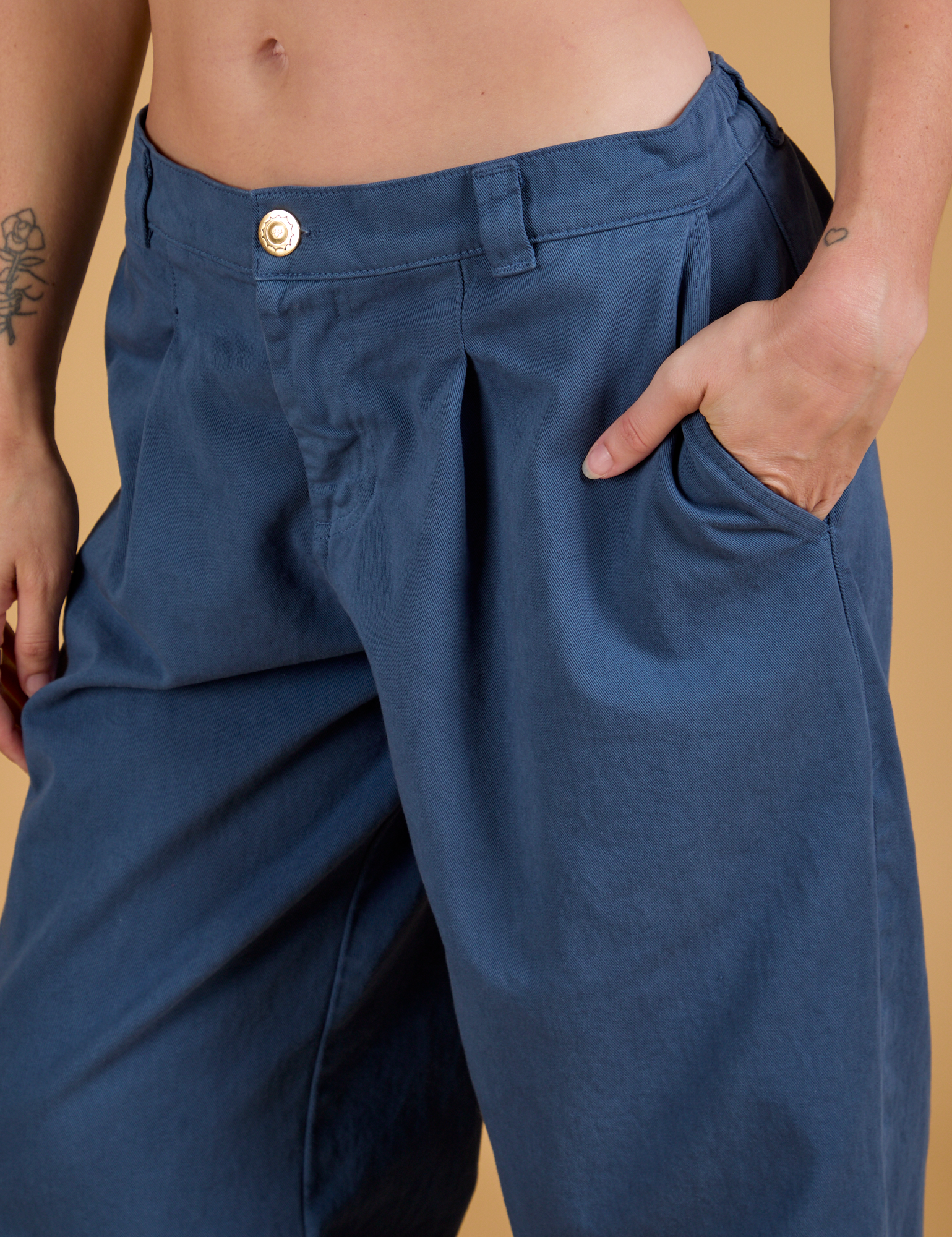 Close up of Alex&#39;s hand in the front pocket of Baggy Mid-Rise Trousers in French Blue