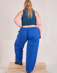 Back view of Mid-Rise Pleated Trousers in Royal Blue and lagoon Cropped Tank on Juliet