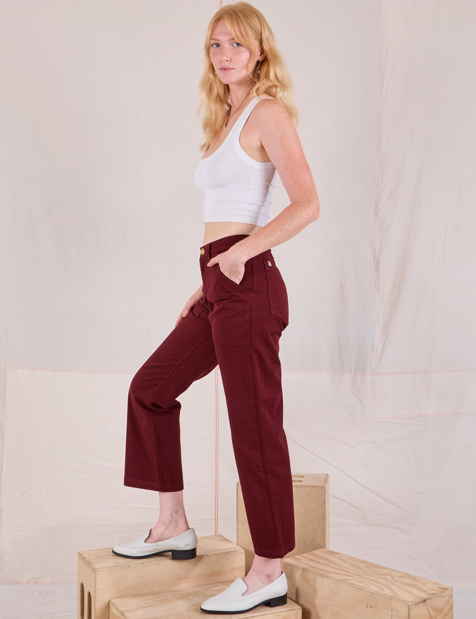 Side view of Mid-Rise Work Pants in Red Wine and Cropped Tank in vintage tee off-white on Margaret