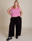 Juliet is wearing Muscle Tee in Bubblegum Pink paired with black Drop Pocket Cargo Pants