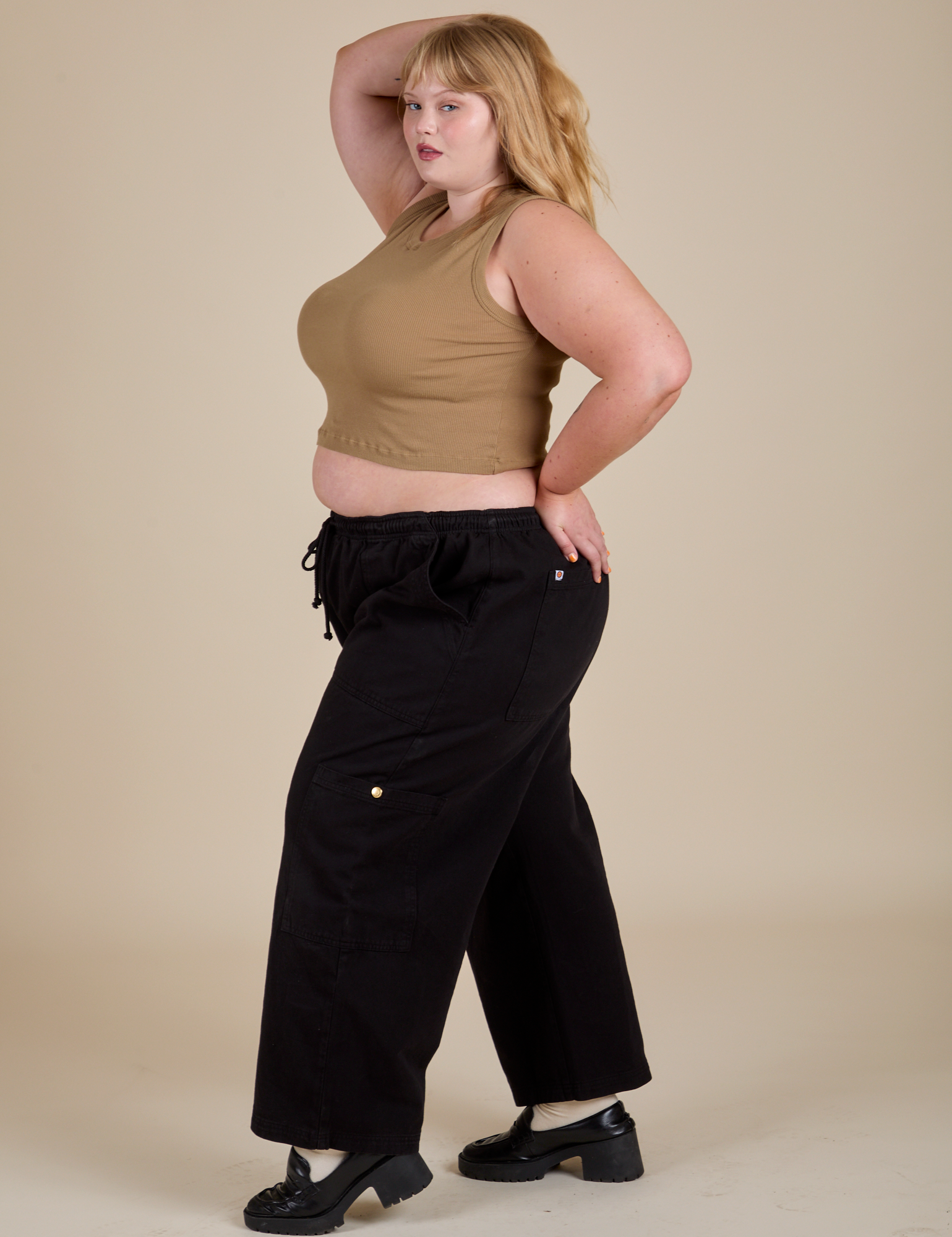 Side view of Muscle Tee in Desert Brown and black Drop Pocket Cargo Pants on Juliet