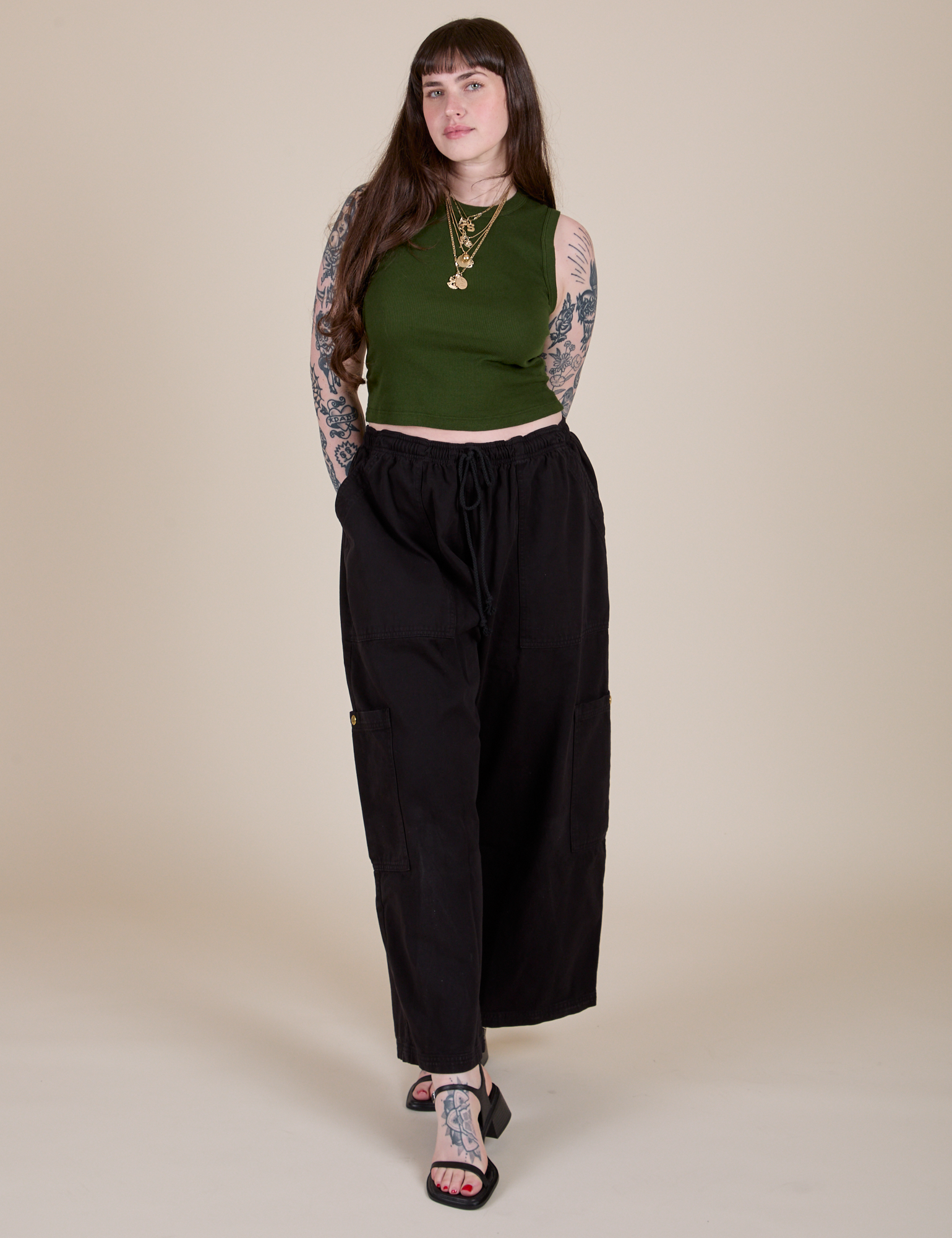Sydney is wearing Muscle Tee in Evergreen paired with black Drop Pocket Cargo Pants