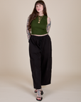 Sydney is wearing Muscle Tee in Evergreen paired with black Drop Pocket Cargo Pants