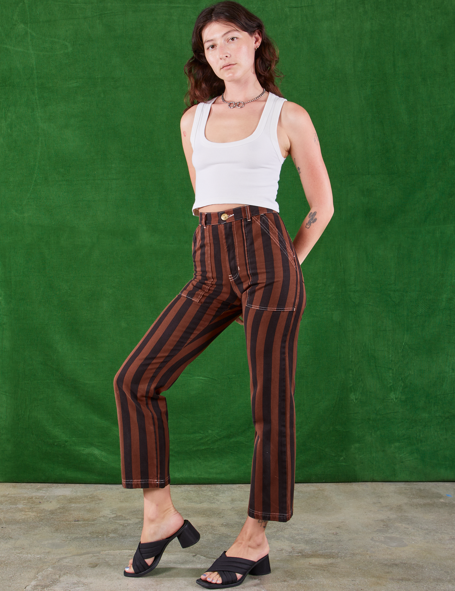 Angled front view of Black Stripe Work Pants in Fudgesicle Brown and Cropped Tank on Alex