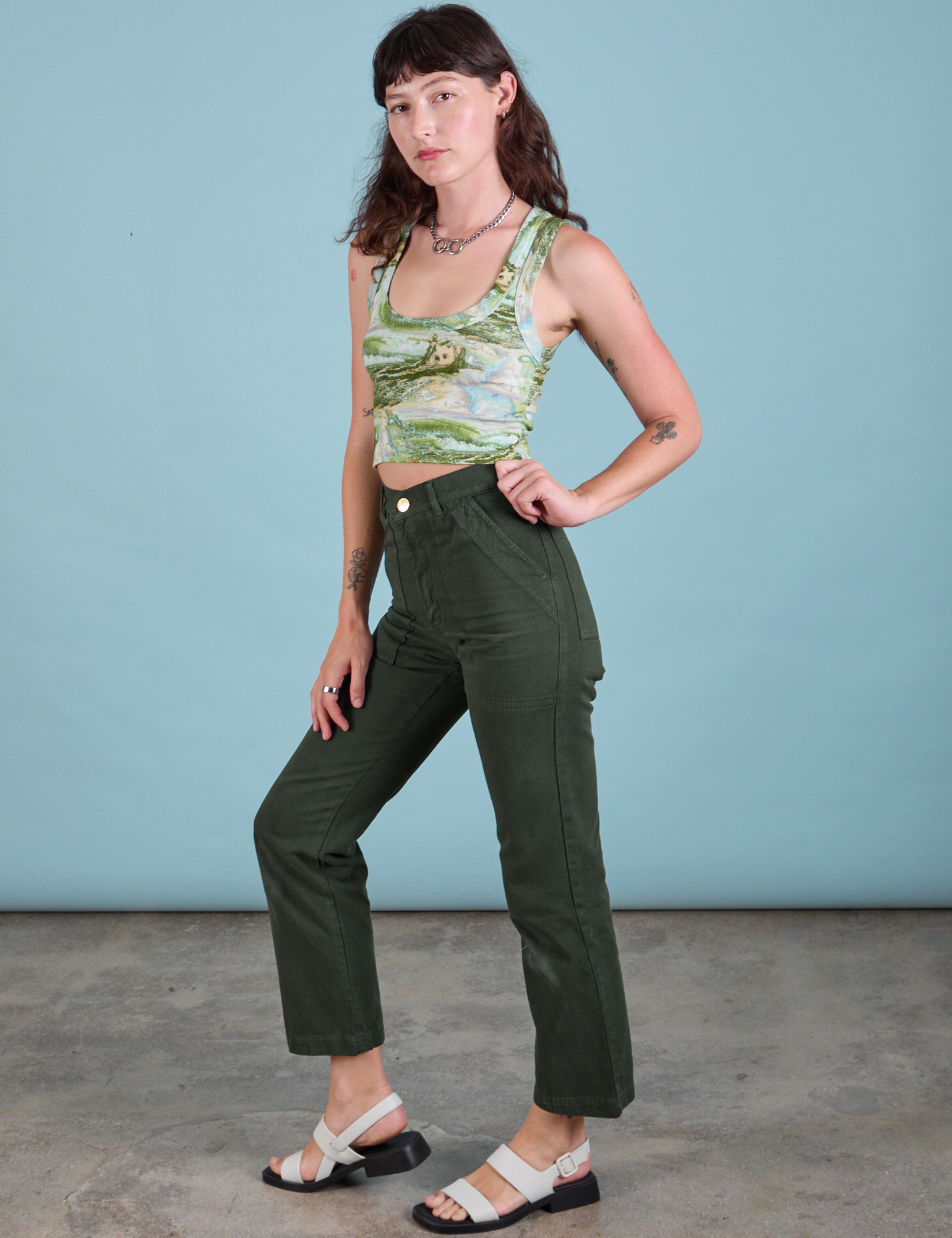 Side view of Cropped Tank Top in Ocean and Sky and swamp green Work Pants on Alex
