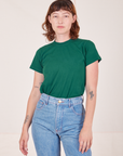 Alex is wearing Organic Vintage Tee in Hunter Green tucked into light wash Frontier Jeans