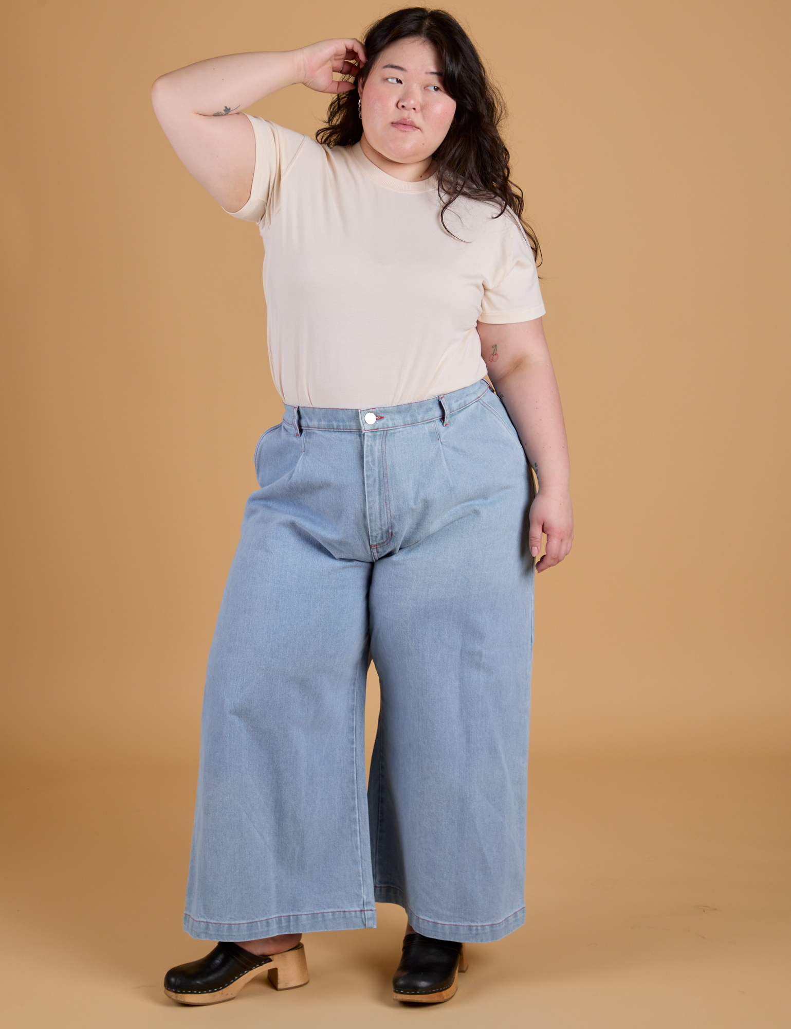 Ashley is wearing Organic Vintage Tee in Vintage Off White tucked into light wash Indigo Wide Leg Trousers
