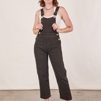 Alex is wearing Original Overalls in Mono Espresso with a vintage off-white Cropped Tank Top.
