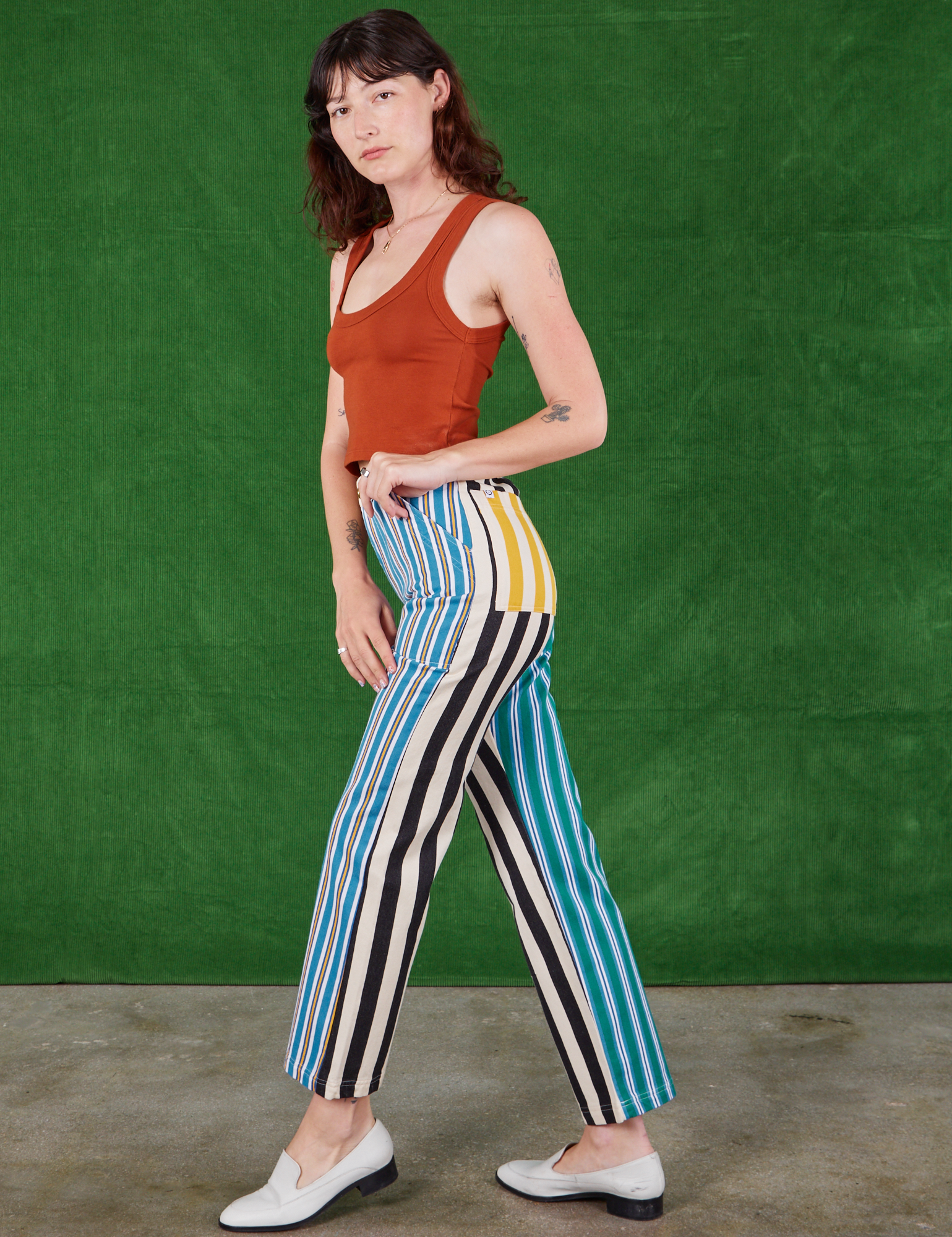 Side view of Mismatched Stripe Work Pants and burnt terracotta Cropped Tank Top on Alex