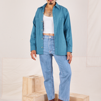 Jesse is wearing Oversize Overshirt in Marine Blue, vintage off-white Cropped Tank Top and light wash Frontier Jeans