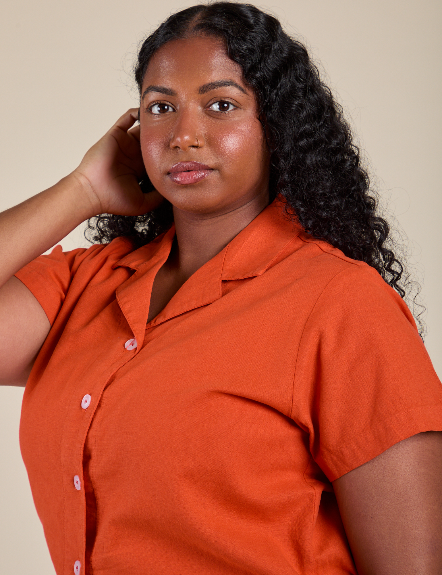 Angled front view of Pantry Button-Up in Chili Red on Meghna