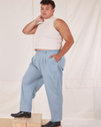 Angled front view of Heavyweight Trousers in Periwinkle and vintage off-white Sleeveless Turtleneck on Miguel