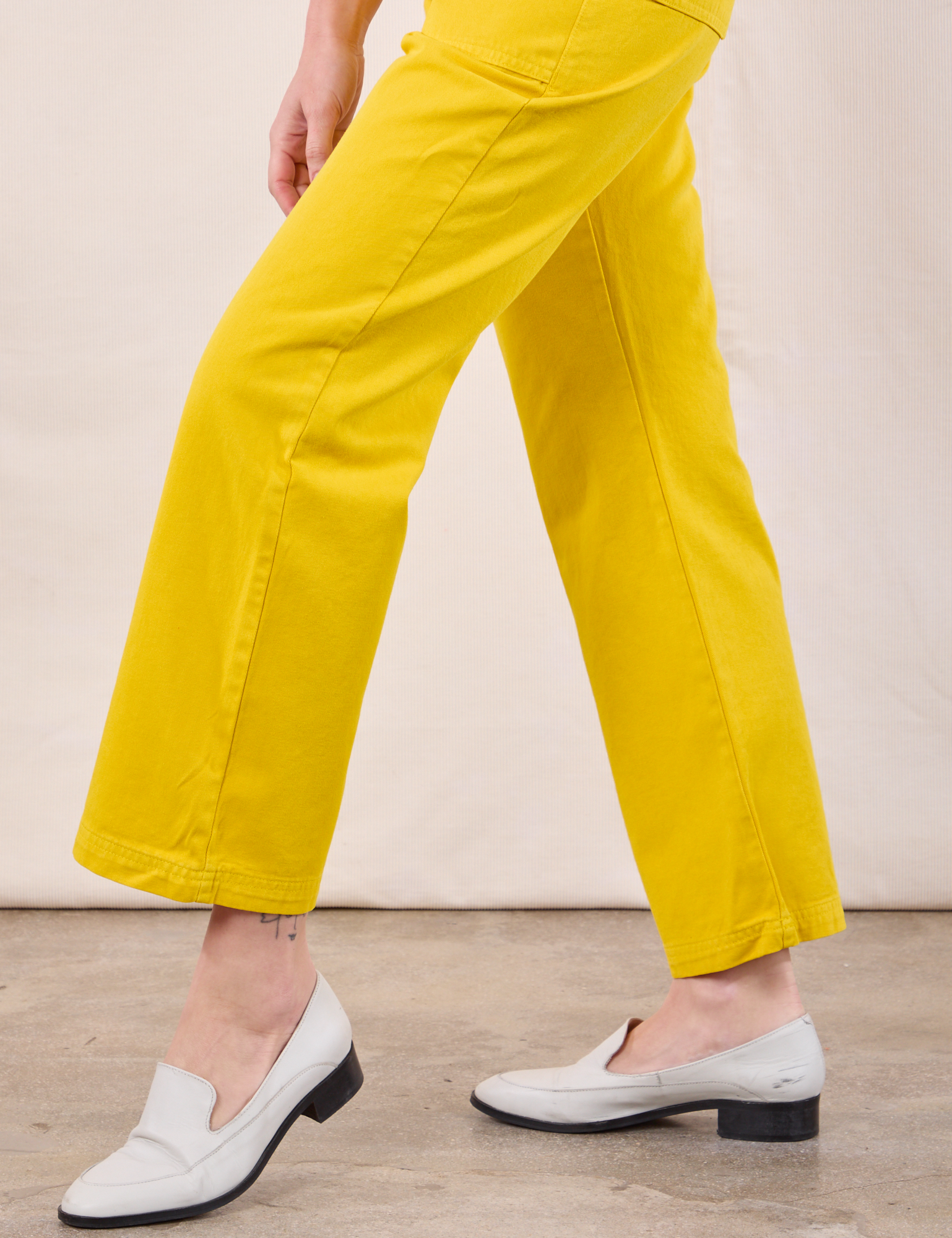 Work Pants in Golden Yellow pant leg close up on Alex