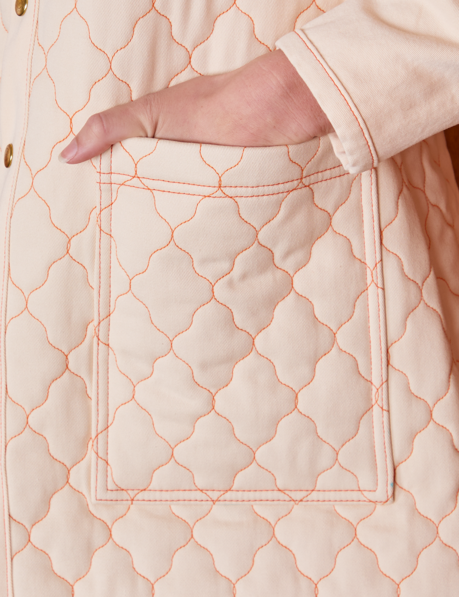Quilted Overcoat in Vintage Off-White pocket close up with Alex&#39;s hand in the pocket