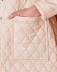 Quilted Overcoat in Vintage Off-White pocket close up with Alex's hand in the pocket