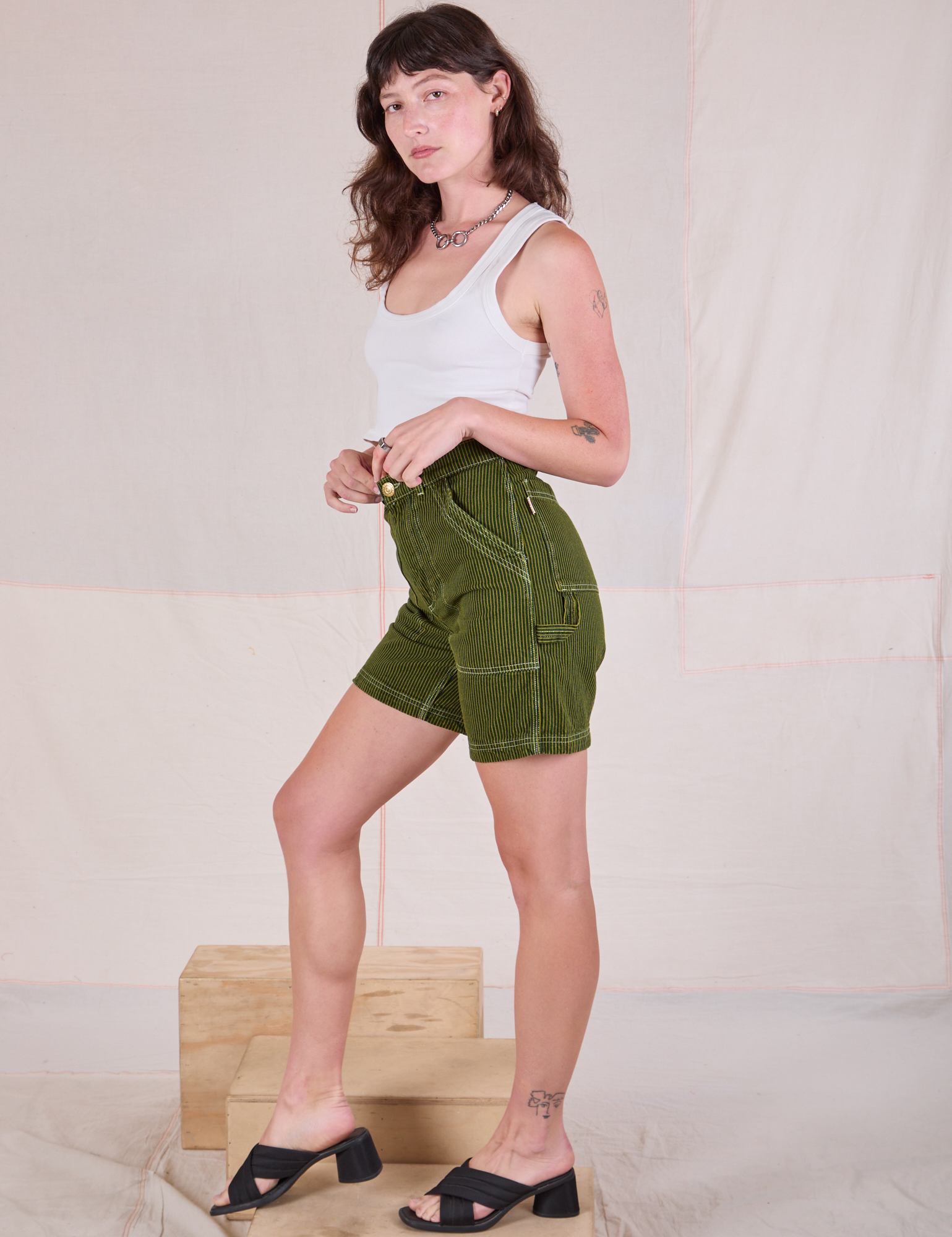 Side view of Railroad Carpenter Shorts in Summer Olive and Cropped Tank in Vintage Tee Off-White on Alex
