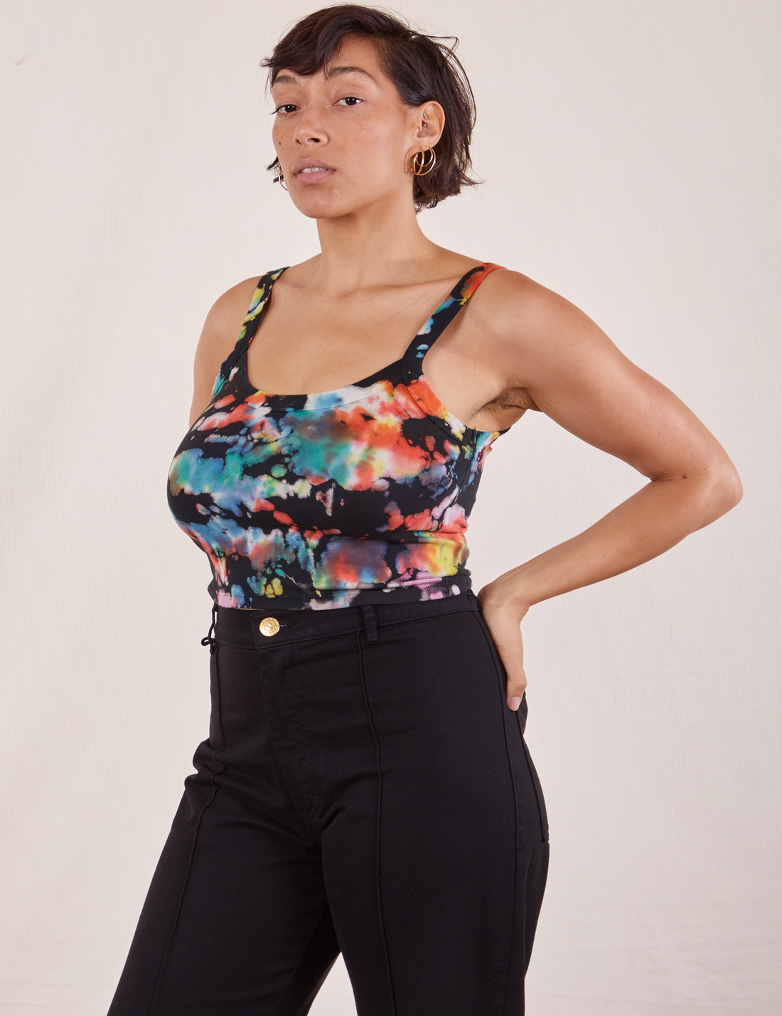 Angled view of Cropped Cami in Rainbow Magic Waters and black Western Pants worn by Tiara