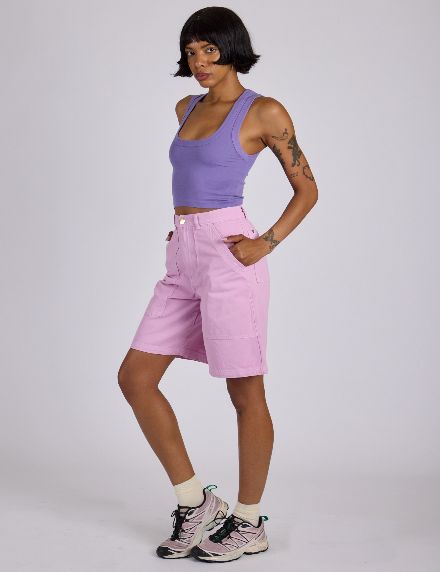 Side view of Longline Work Shorts in Lilac Purple and faded grape Cropped Tank on Kira