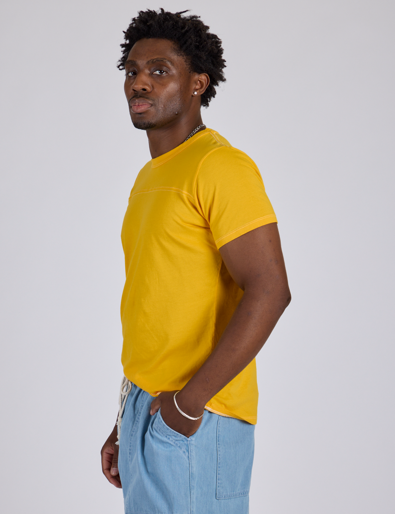 Jr. Varsity Tee in Sunshine Yellow side view on Isaac