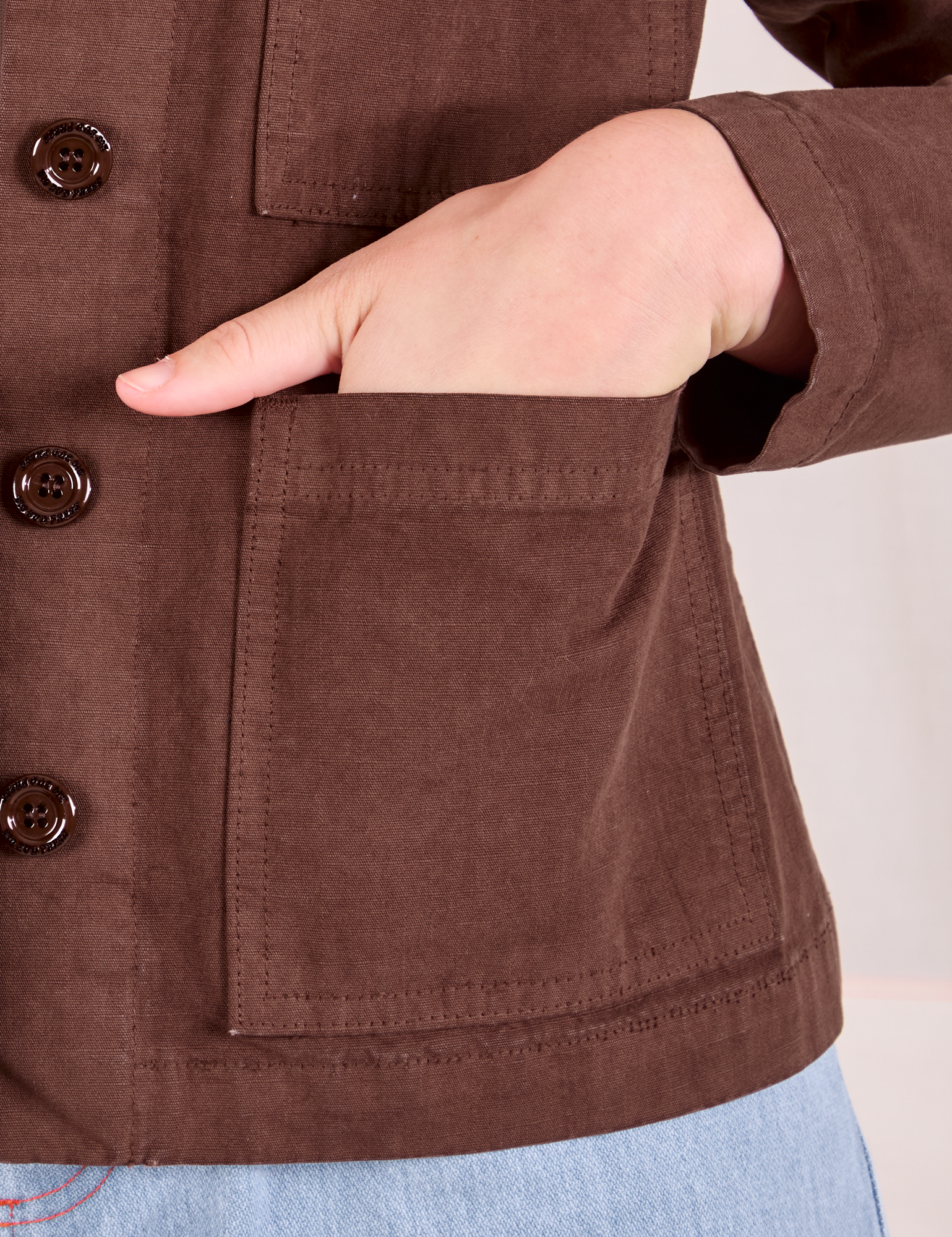 Ripstop Work Jacket in Fudgesicle Brown front pocket close up. Alex has her hand in the pocket.