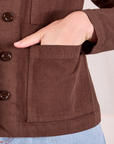 Ripstop Work Jacket in Fudgesicle Brown front pocket close up. Alex has her hand in the pocket.