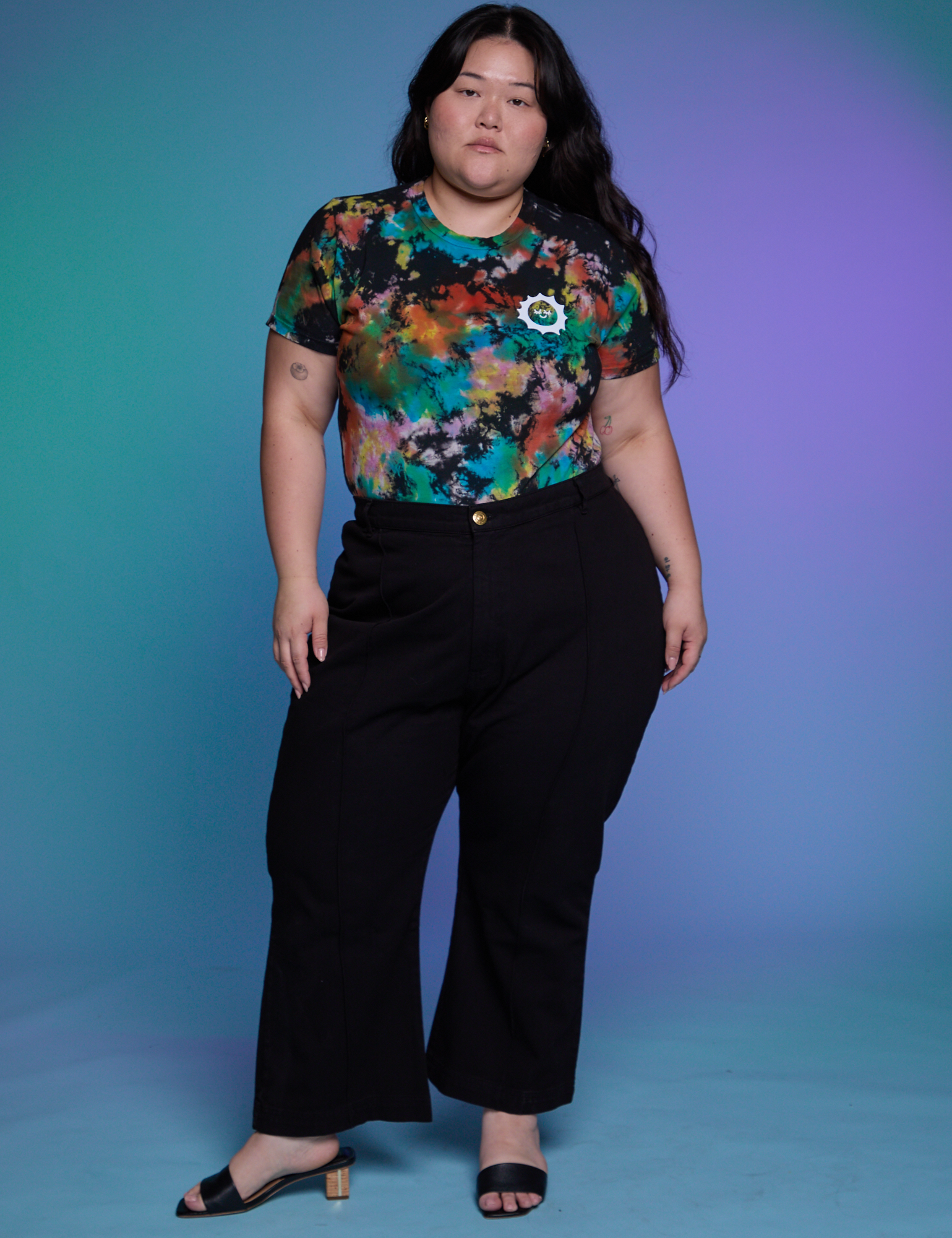 Ashley is wearing Classic Tee in Rainbow Magic Waters and black Western Pants