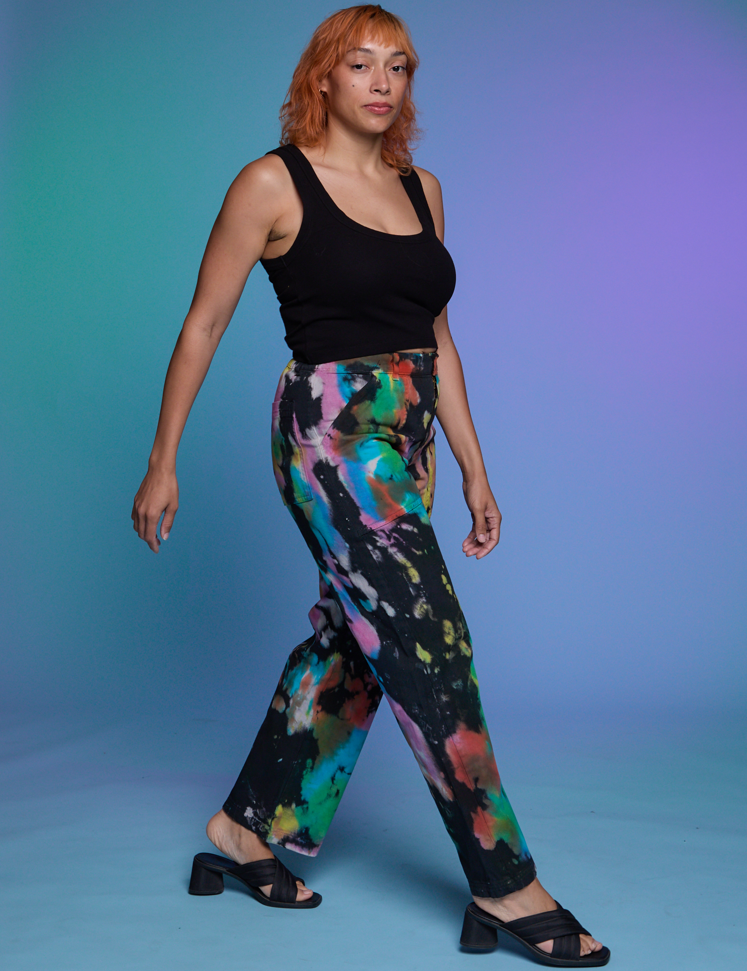 Angled front view of Work Pants in Rainbow Magic Waters and black Cropped Tank on Tiara