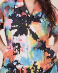 Front close up of Petite Short Sleeve Jumpsuit in Rainbow Magic Waters worn by Ashley