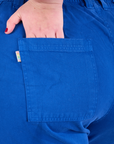 Bell Bottoms in Royal Blue back pocket close up with Juliet's hand in the pocket.