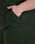 Close up of Ashley's hand in the front pocket of Short Sleeve Jumpsuit in Swamp Green