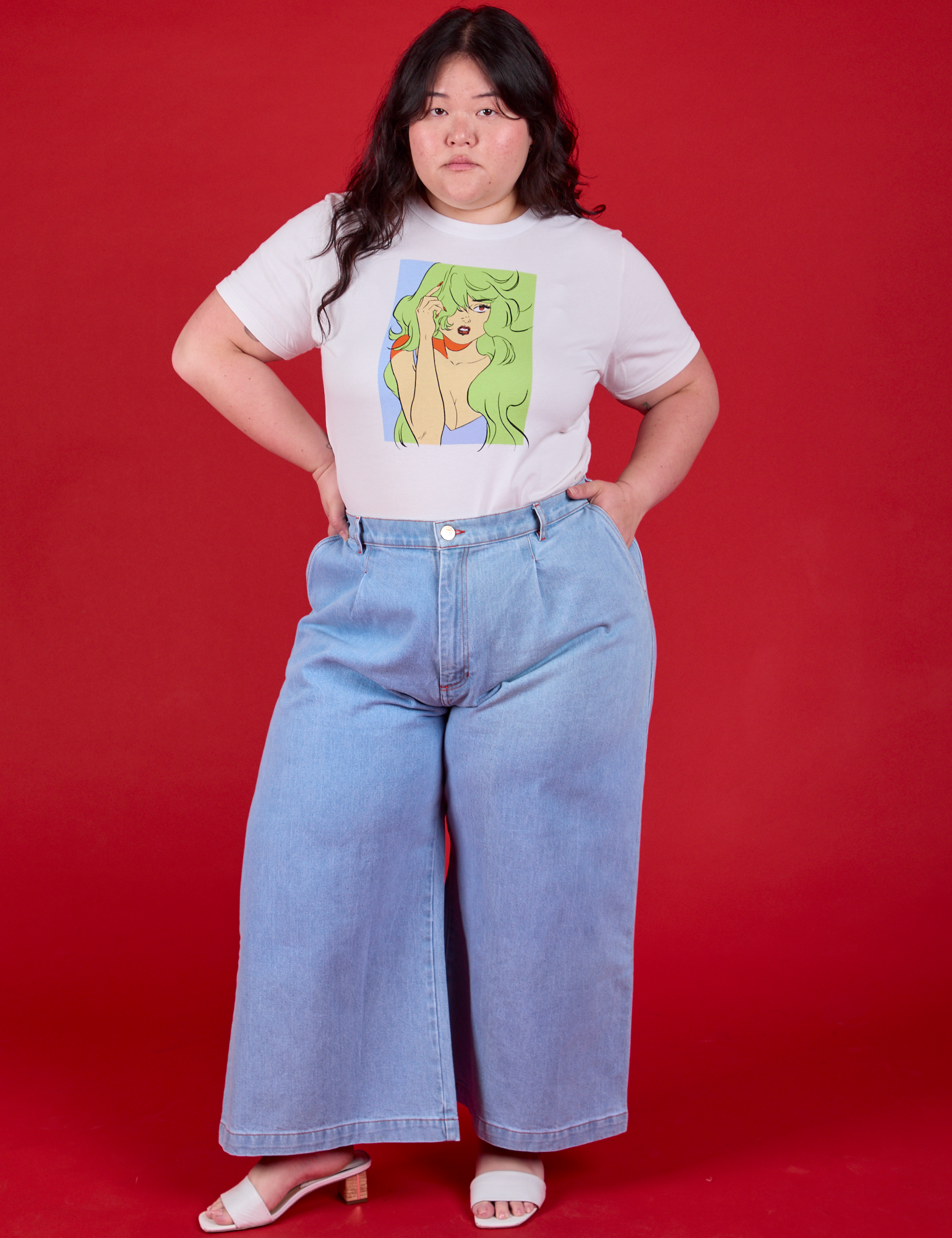 Ashley is wearing Snotgirl Comic Tee tucked into Wide Leg Trousers in Light Denim
