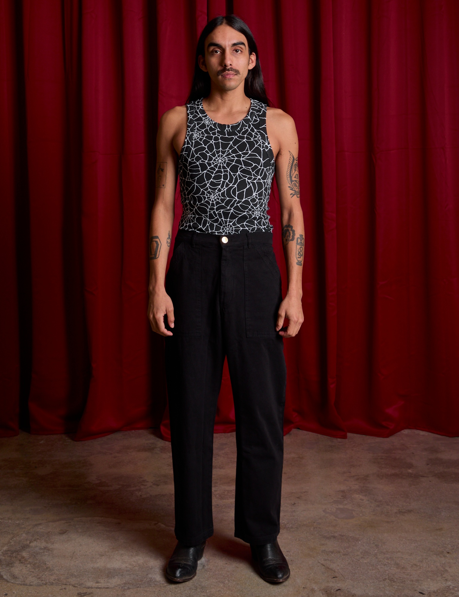 Spider Webs Racerback Tank and black Work Pants worn by Anthony