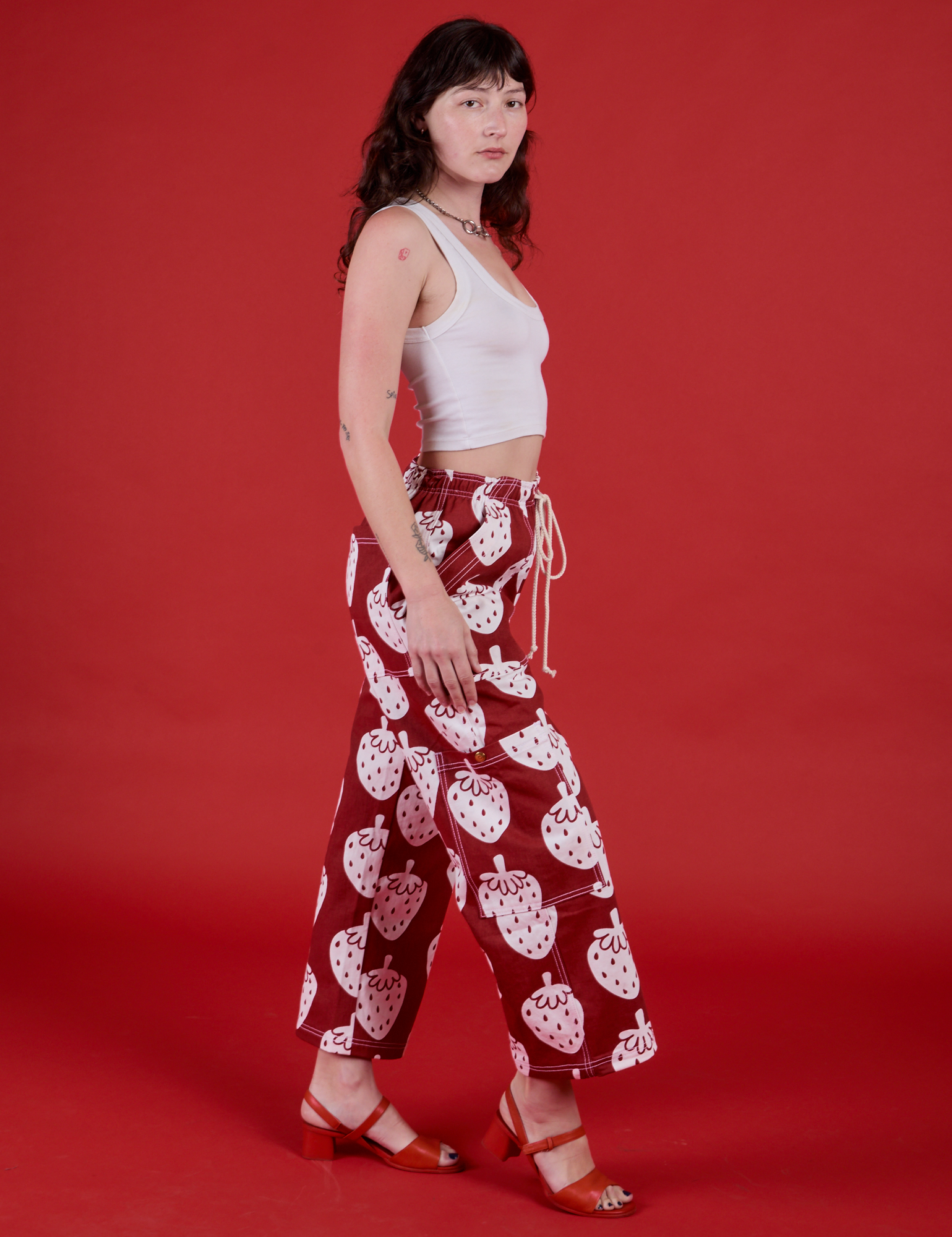 Side view of Drop Pocket Pants in Strawbaby and Cropped Tank in Vintage Tee White on Alex