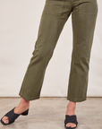 Short Sleeve Jumpsuit in Surplus Green front pant leg close up on Alex