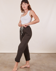 Angled view of Cropped Rolled Cuff Sweatpants in Espresso Brown and vintage off-white Cropped Tank Top on Alex