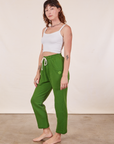 Side view of Cropped Rolled Cuff Sweatpants in Lawn Green and vintage off-white Cami on Alex