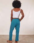 Back view of Cropped Rolled Cuff Sweatpants in Marine Blue and vintage off-white Cami on Jerrod