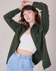 Alex is wearing Flannel Overshirt in Swamp Green, vintage off-white Cropped Cami and light wash Trouser Jeans