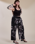 Angled front view of Magic Waters Drop Pocket Pants in Ink Blot and black Cropped Tank