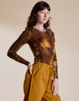 Angled front view of Long Sleeve Baby Tee in Honey Brown on Alex