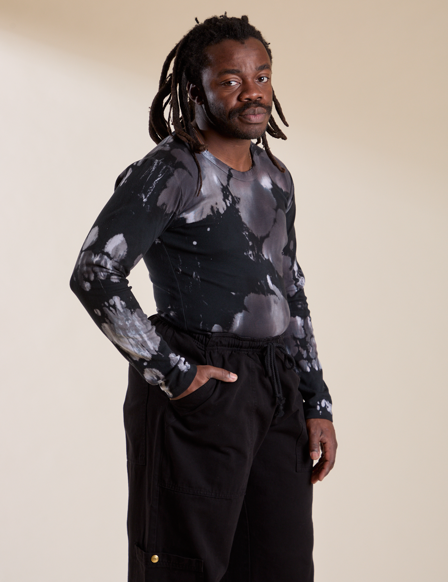 Angled front view of Long Sleeve Baby Tee in Ink Blot on Demi