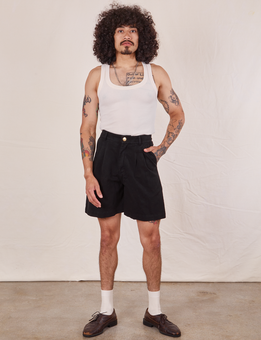 Jesse is 5'8" and wearing XXS Trouser Shorts in Basic Black paired with a vintage off-white Tank Top