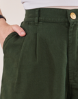 Trouser Shorts in Swamp Green front close up. Hana has her hand in the pocket.