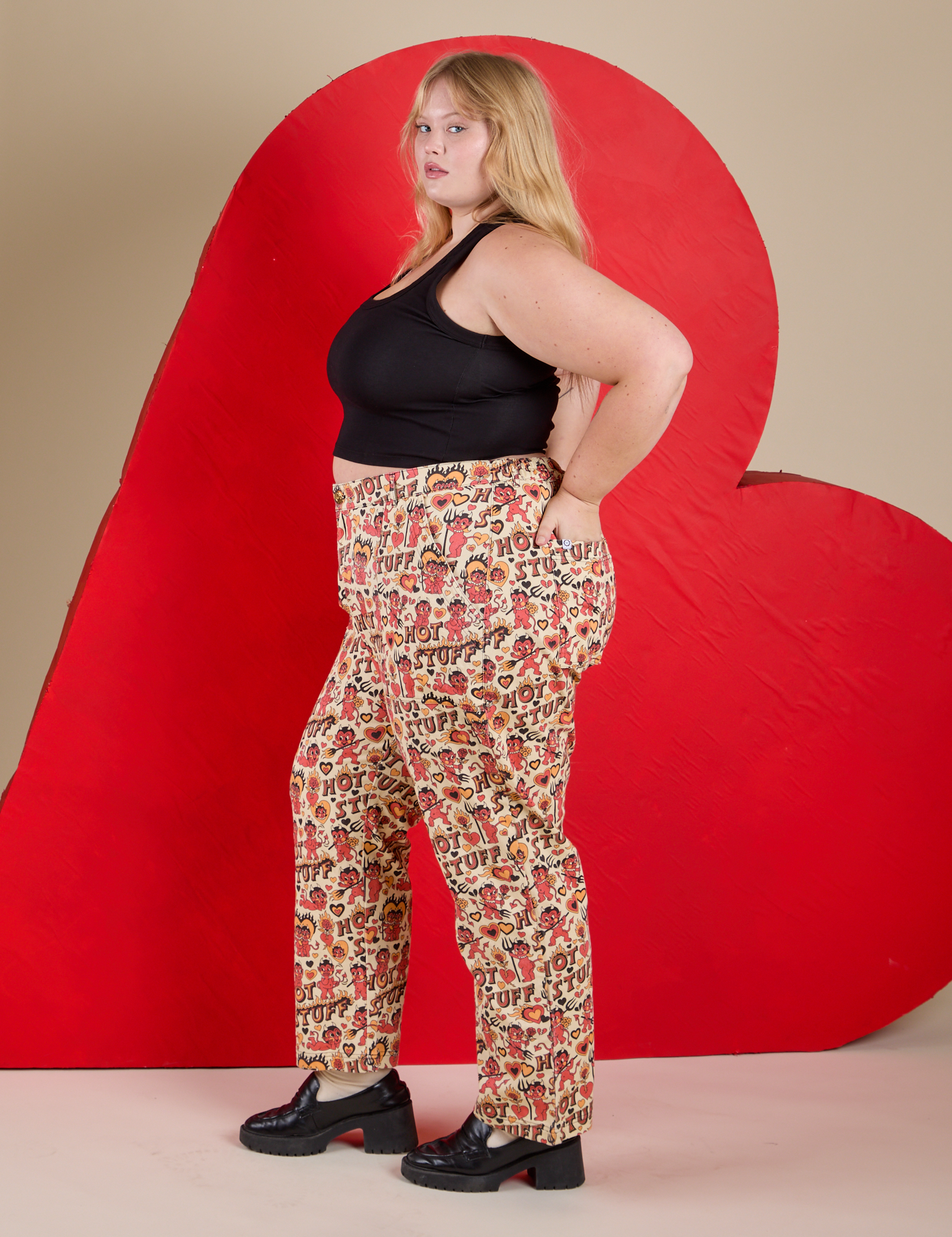Side view of Work Pants in Hot Stuff Print and black Cropped Tank on Juliet
