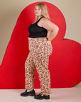 Side view of Work Pants in Hot Stuff Print and black Cropped Tank on Juliet