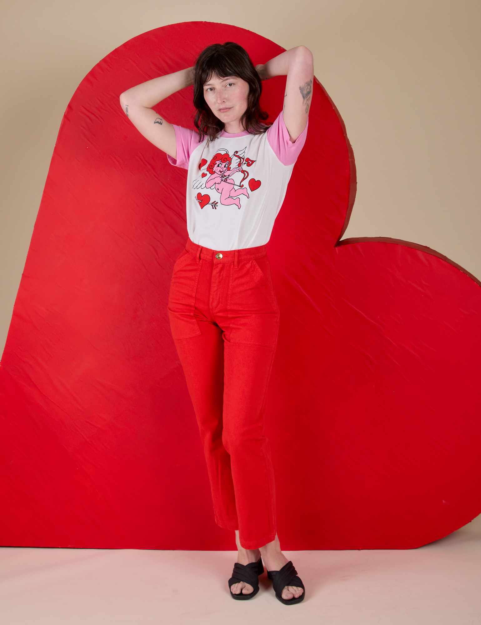 Alex is wearing Vintage Tee in Cupid paired with mustang red Work Pants