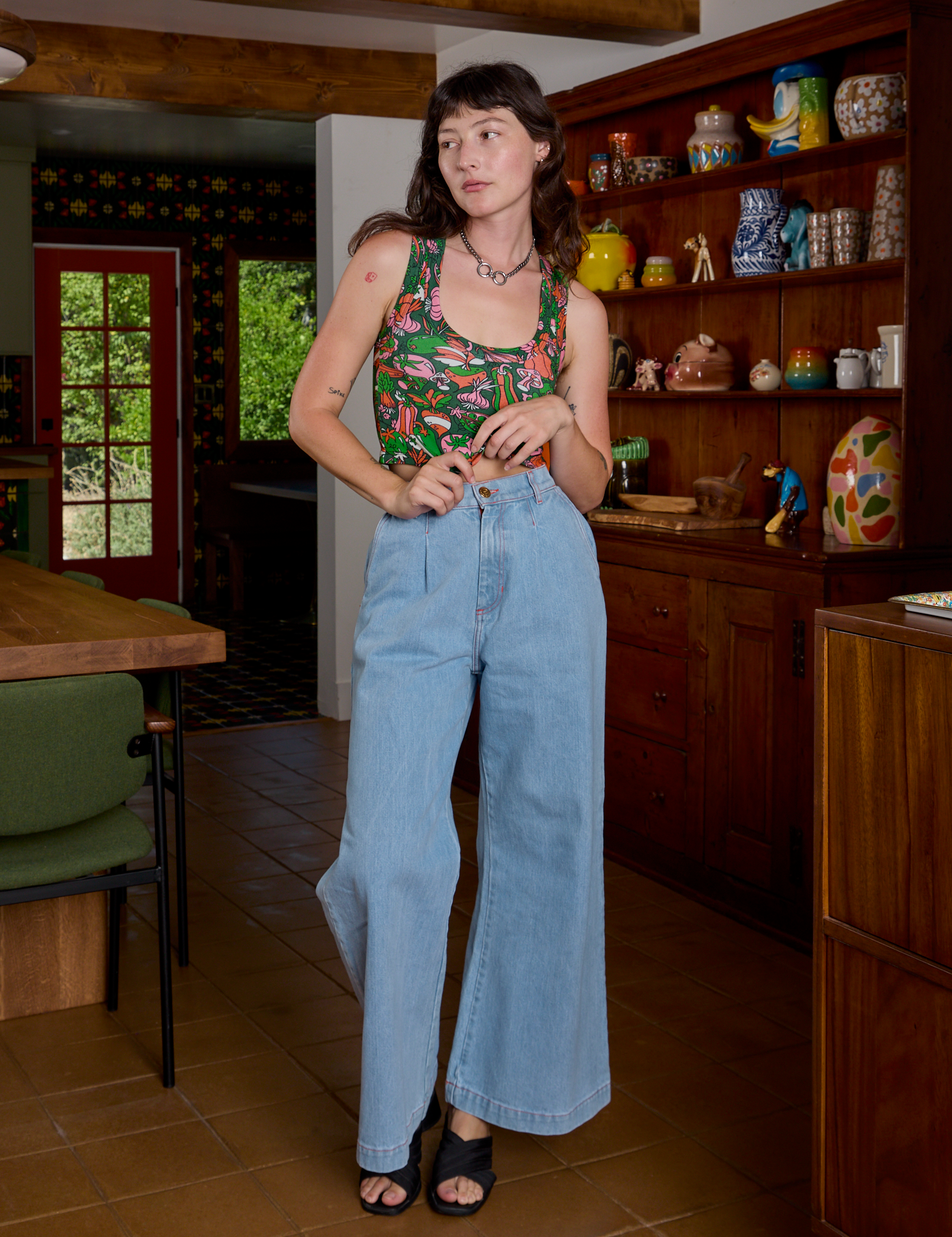 Alex is wearing Cropped Tank Top in Kitchen Collection and light wash Indigo Wide Leg Trousers