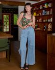 Alex is wearing Cropped Tank Top in Kitchen Collection and light wash Indigo Wide Leg Trousers